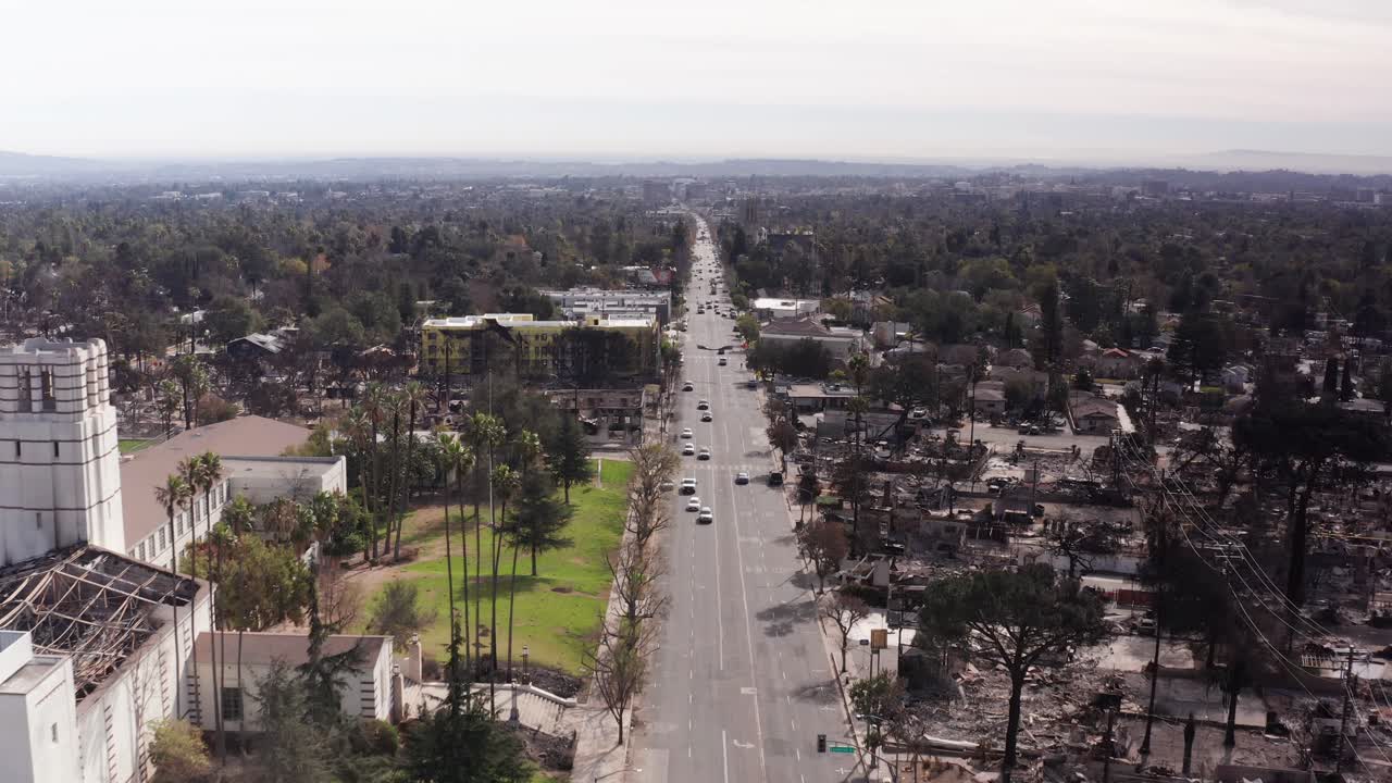 Low aerial shot flying south over Lake Street in downtown Altadena after the Eaton Fire. 4K