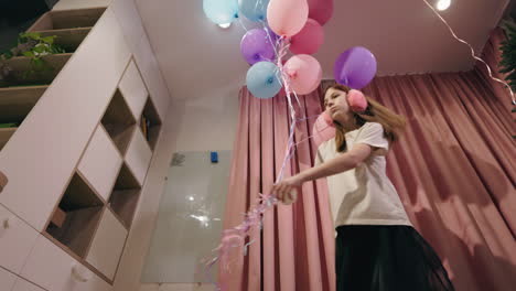 girl celebrating birthday with balloons