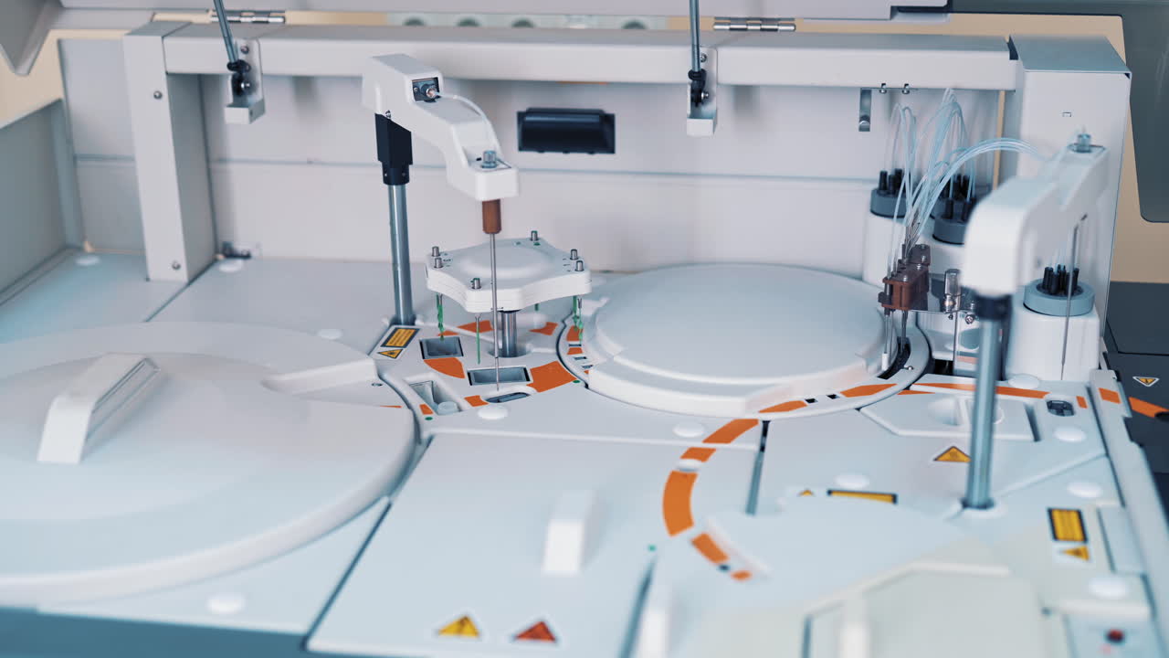 Modern robotic machine of checking blood samples in process in the laboratory. Analysis of liquid at medical clinic. Reseach and science concept. Slow motion.