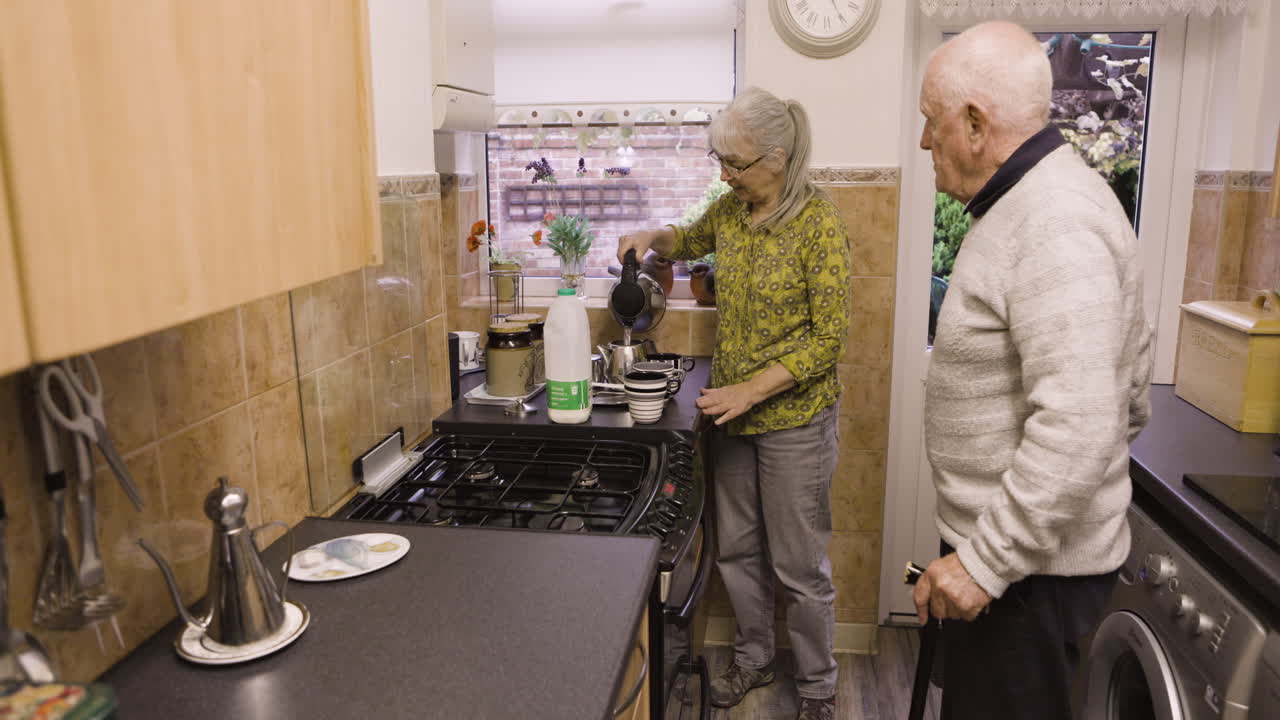 Elderly couple making tea in the kitchen