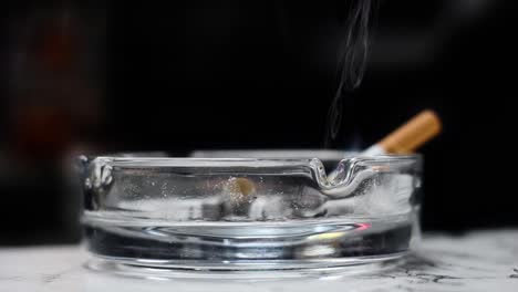 a cigarette is placed in an ashtray