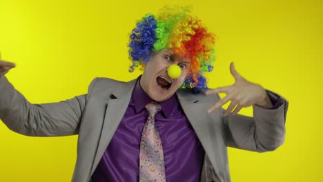 clown businessman entrepreneur dancing, celebrate, making silly faces at work