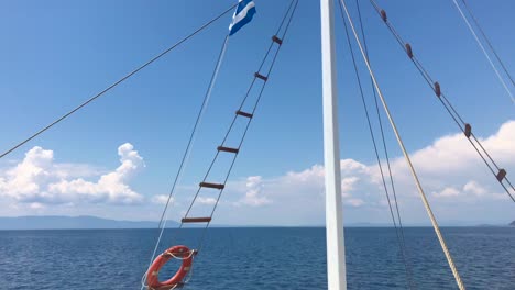 Front-view-of-sailing-ship-on-blue-Mediterranean-sea-in-Sithonia,-Greece-in-4k