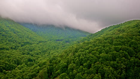 smoky mountain ridges cloaked in thick morning fog via drone