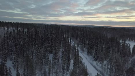 Coches-Circulando-Por-Un-Paisaje-Cubierto-De-Nieve-Cerca-De-Kuusamo,-Finlandia