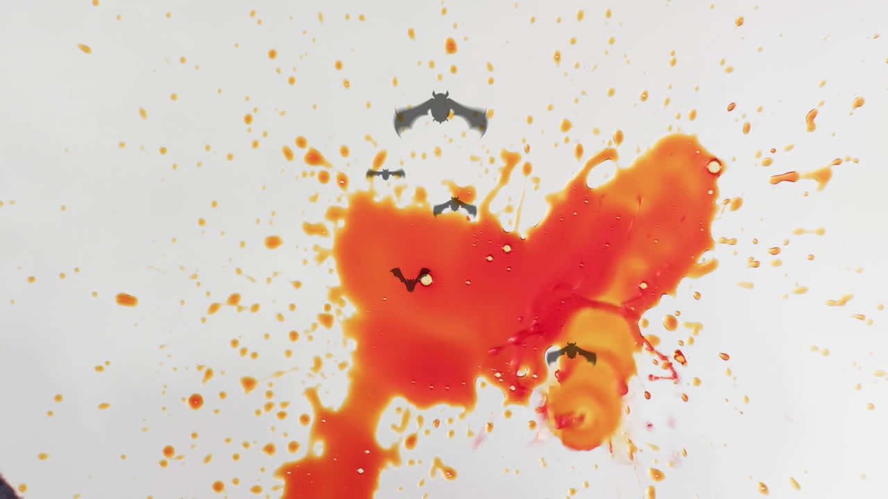 Orange and red liquid splashes with flying bats animation