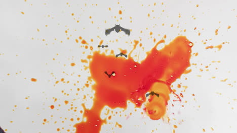 orange and red liquid splashes with flying bats animation