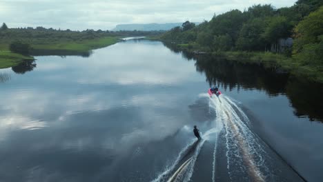 waterskier cutting on slalom ski aerial tracking shot