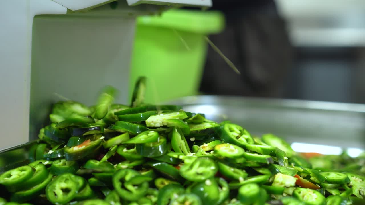 Fresh Green Jalapeño Peppers Being Sliced in a Kitchen