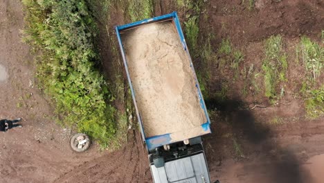 dump truck loading sand on construction site