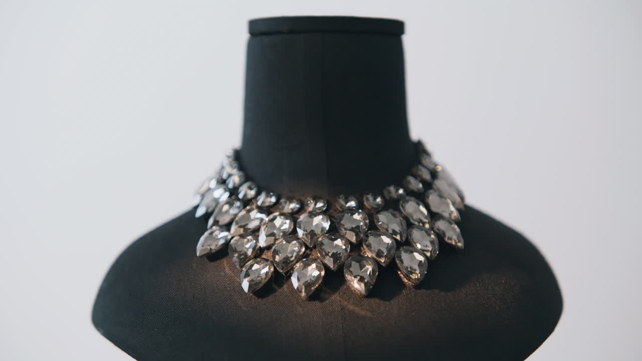 Fashion jewelry collar shining on mannequin inside neutral studio closeup