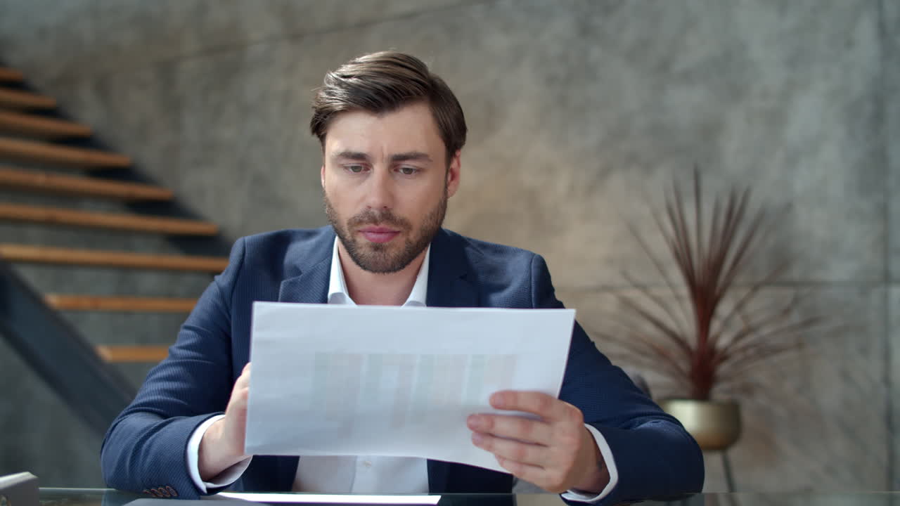 Focused businessman working with documents in office