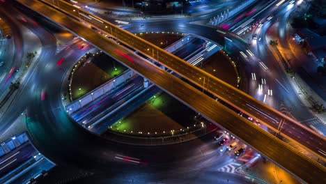 4k time lapse aerial view road roundabout intersection in the city at night with vehicle car light movement.