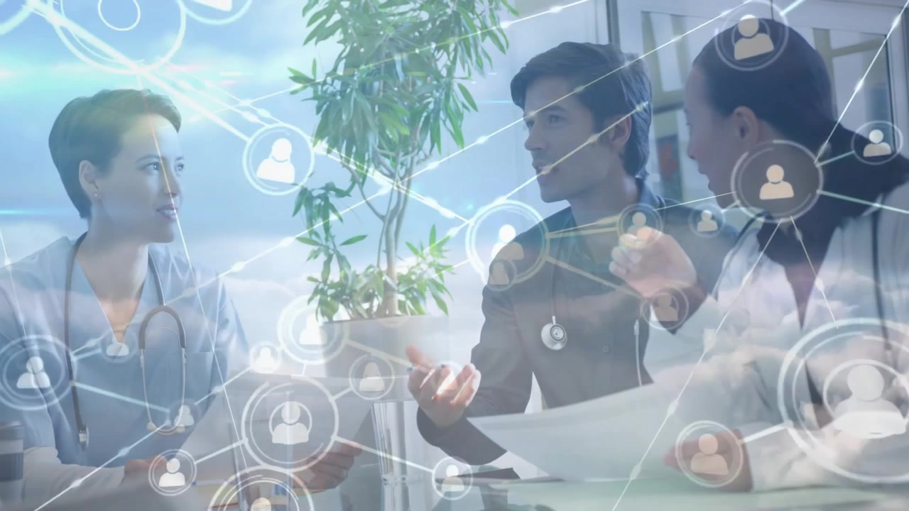 Group of medical professionals discussing paperwork at conference table displaying network icons