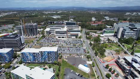 aerial view of modern cityscape with hospital and residential buildings under construction