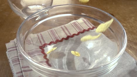 Crispy-yellow-corn-flakes-into-the-bowl-for-the-morning-a-delicious-Breakfast-with-milk.-Slow-motion-with-rotation-tracking-shot.