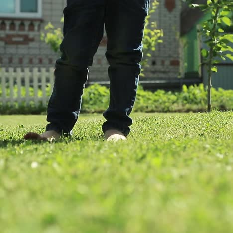 happy kid jumping in green field