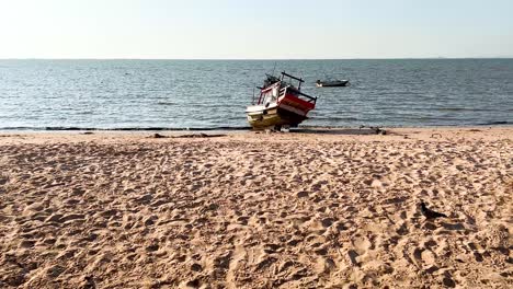 a boat is stranded on a sandy beach