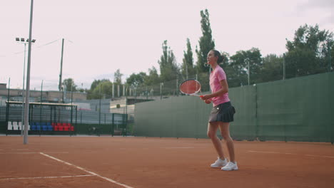 athletic young woman tennis player. portrait of handsome woman with tennis racket in the tennis uniform walking outdoor.