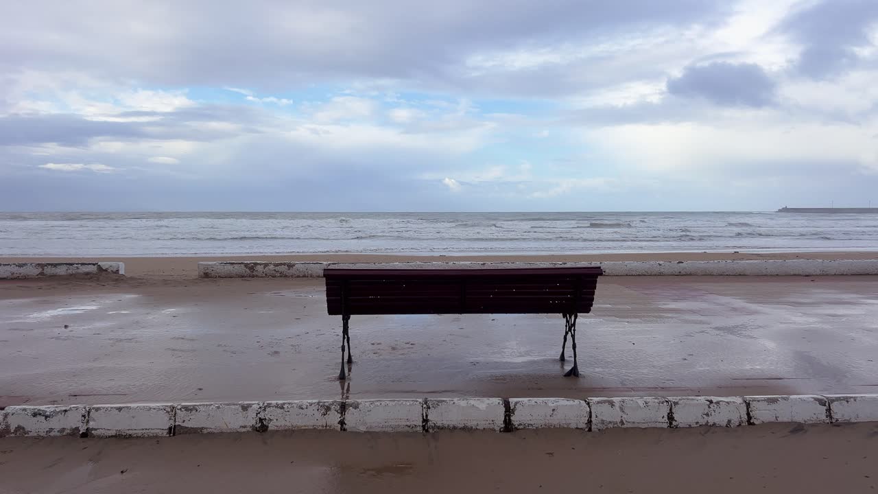 A solitary bench on the promenade of the Atlantic Ocean
