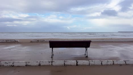 a solitary bench on the promenade of the atlantic ocean