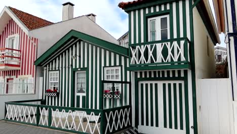 Panning-left-along-some-super-colorful-houses-in-Praia-da-Costa-Nova-near-Aveiro,-Portugal