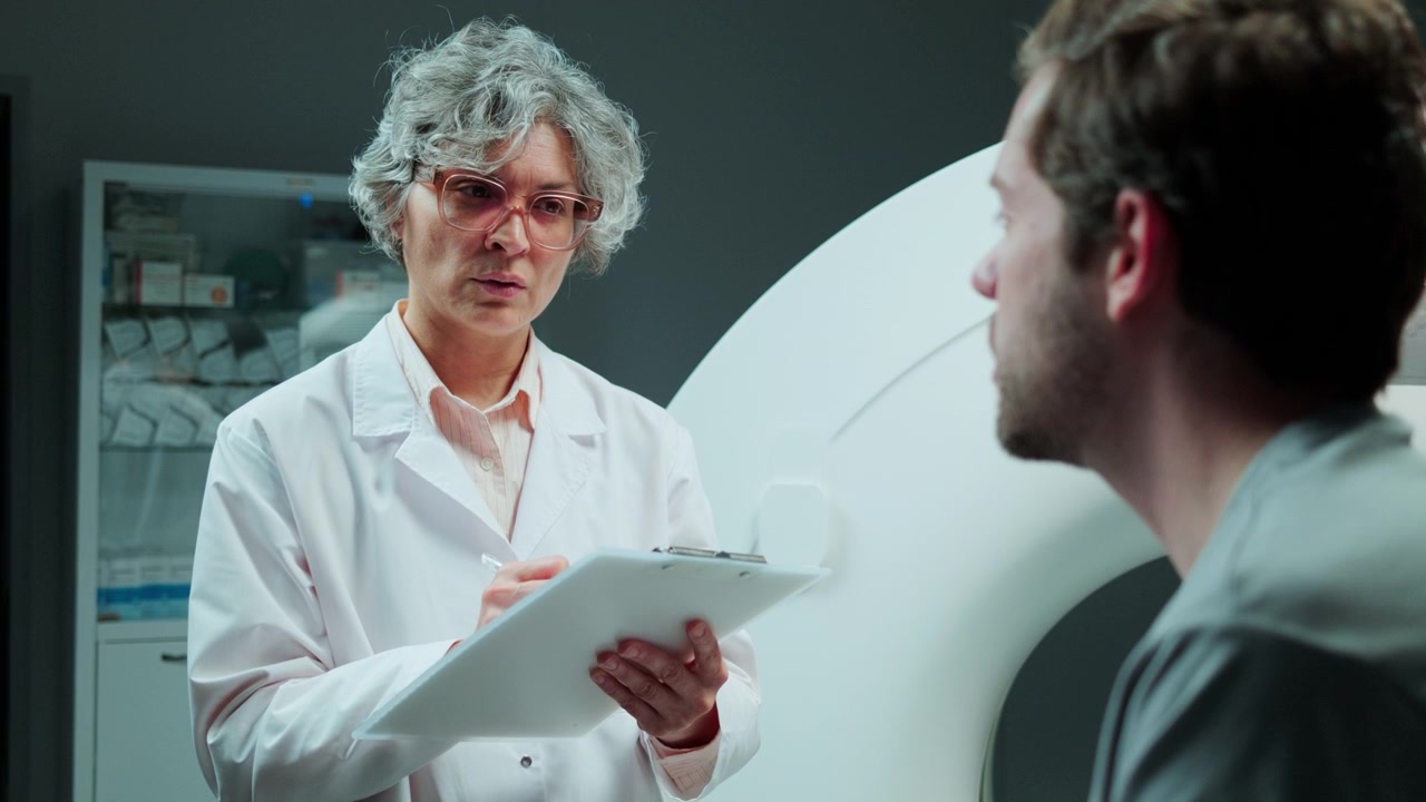 Female Radiologist Questioning Patient before CT Scan at Diagnostic Center