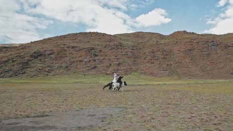 nomadic mongolian horse riders galloping across altai mountains steppe