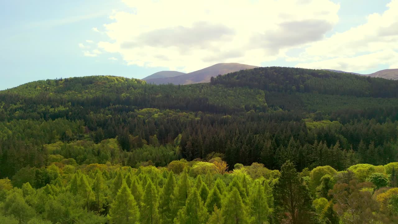 Rising aerial video of the Mourne Mountains and Slieve Donard in Newcastle, County Down in Northern Ireland, UK on a bright and sunny day. Filmed in 4K, 60fps and with Rec709 Color.