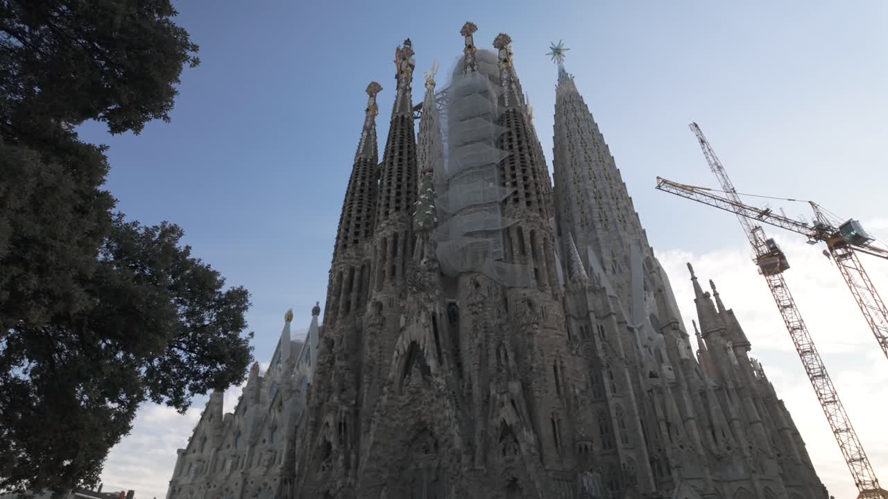 Close up establishing pan right of La Sagrada Familia ornate spires and modernist architectural details in Barcelona