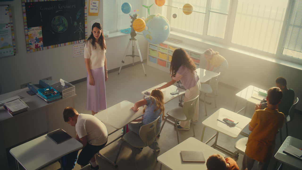 Knee Level Shot of Primary School Children Entering Modern Classroom Unpacking Their Backpacks
