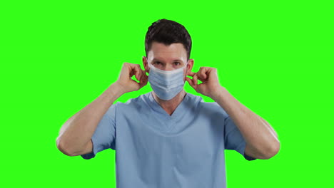 Caucasian-male-doctor-wearing-face-mask-on-green-screen-background