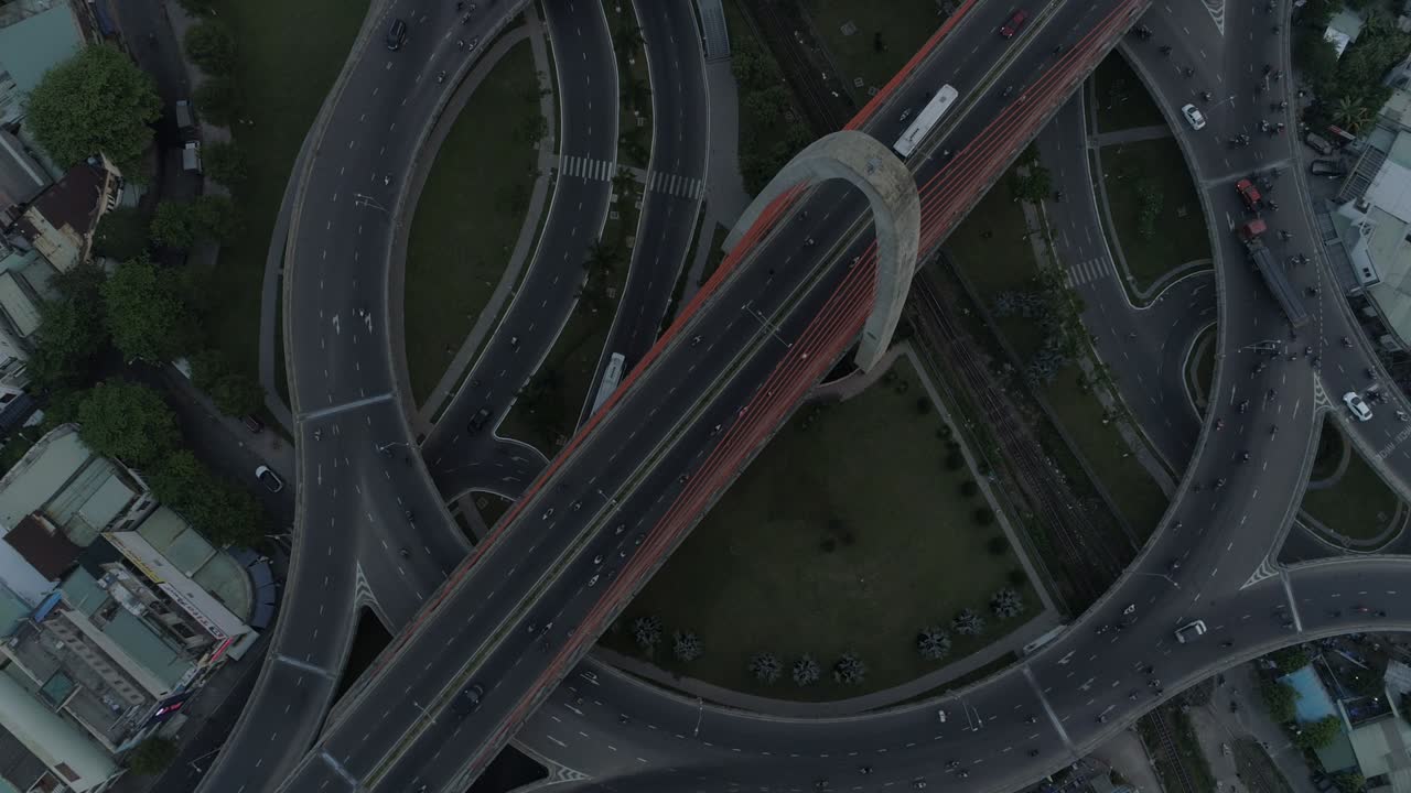 Aerial drone footage of multi-level complex overpass transport in Asia, loaded with traffic. Urbanization and development concept.