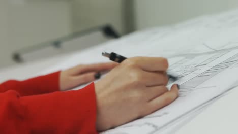close-up of female executive working on blueprint 4k