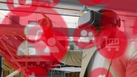 Multiple-red-digital-icons-over-african-american-senior-businessman-wearing-a-vr-headset-at-office