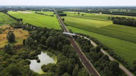 aerial view of rural dutch landscape with train tracks and farmland