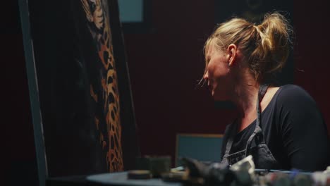 woman painting an animal portrait in studio
