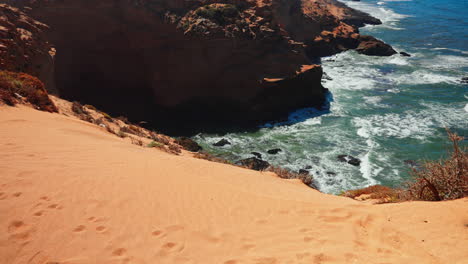 closeup shot of the rocky coastline at tamri sand dunes in morocco. arid natural desert landscape.