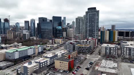 Aerial-view-approaching-downtown-Seattle-panoramic-cityscape-skyscraper-overcast-skyline