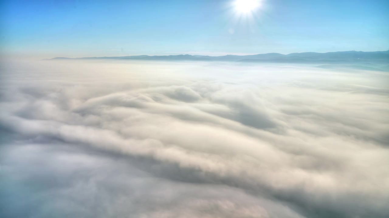 Aerial View of Thick Clouds Covering the Landscape at Sunrise