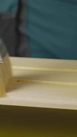 painting a light yellow wooden panel