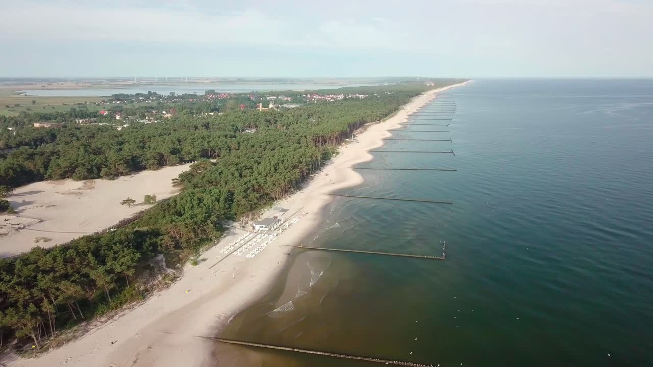 Aerial footage of a fine summer day on the Polish seaside. Baltic seashore free of tourists, early in the morning.