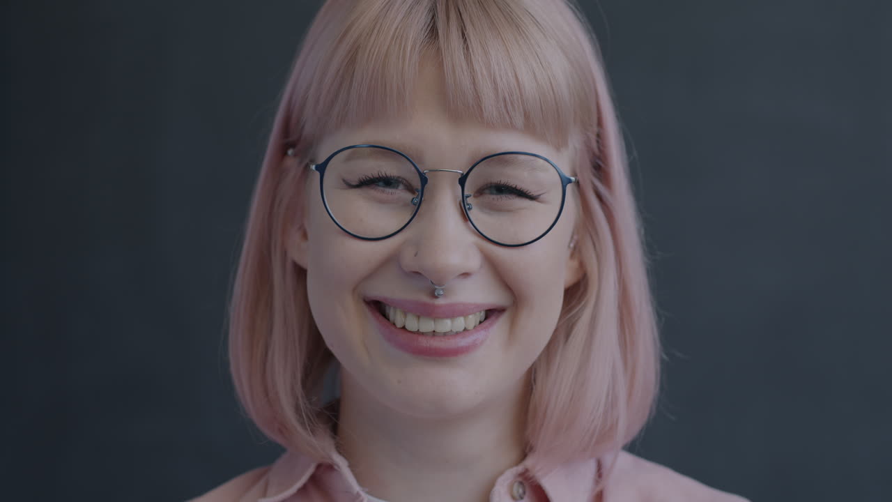 Smiling Woman with Pink Hair and Glasses