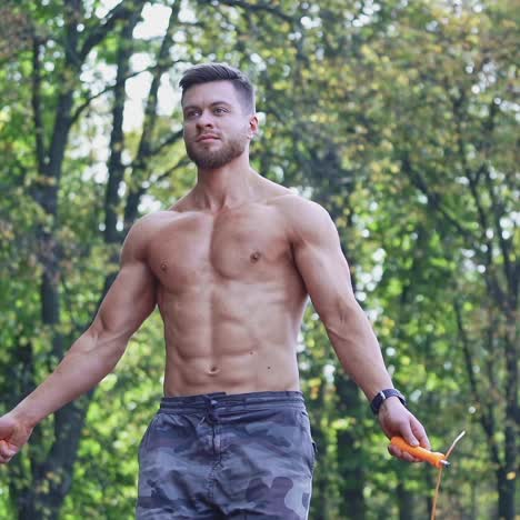 . man exercising with jump rope. athletic sportsman jumping on skipping rope in park