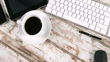 digital tablet, smartphone, cup of tea, keyboard and mouse