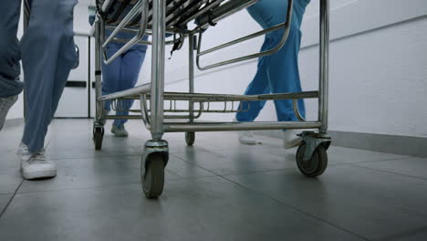 Medics-legs-running-down-hospital-corridor-rolling-gurney-to-emergency-room.