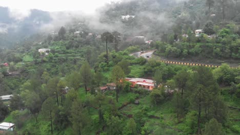 Aerial-View-Over-Green-Hillside-With-Four-Lane-E75-Expressway-And-Fog-Hanging-In-Air