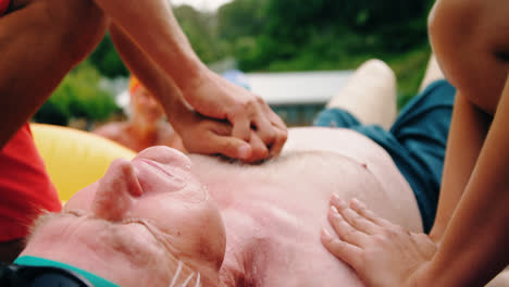 lifeguards performing resuscitation procedure on man