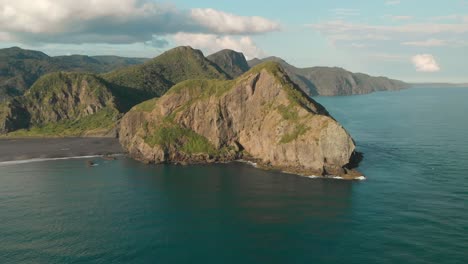 Flying-from-incredible-rock-formation-on-vulanic-Whatipu-Beach-in-New-Zealand