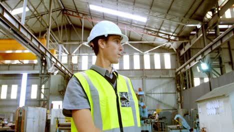 male engineer motivating workers in workshop 4k